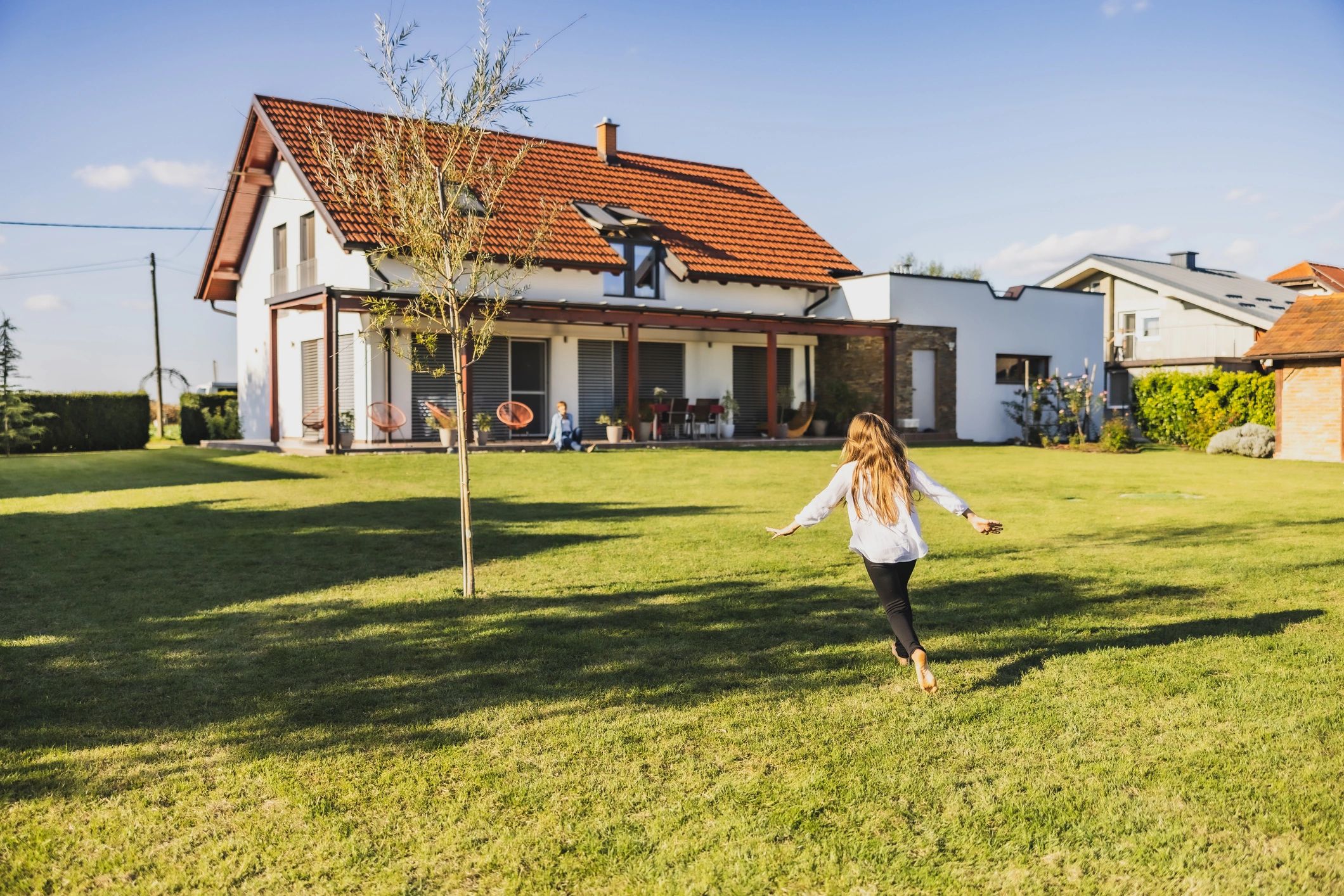 happy homeowner with green lawn